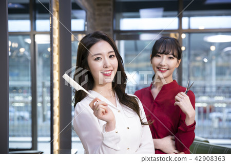 Hairdresser styling woman's hair in a salon. Korean beauty stock photo. 153 Hairdresser styling woman's hair in a salon. Korean beauty stock photo. 153 42908363