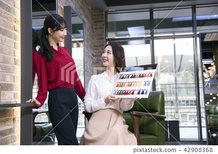 Hairdresser styling woman's hair in a salon. Korean beauty stock photo. 149 Hairdresser styling woman's hair in a salon. Korean beauty stock photo. 149 42908368