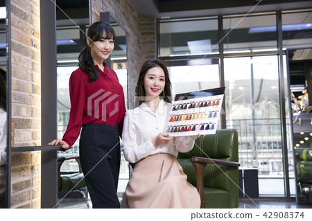 Hairdresser styling woman's hair in a salon. Korean beauty stock photo. 148 Hairdresser styling woman's hair in a salon. Korean beauty stock photo. 148 42908374