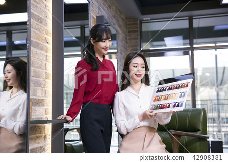 Hairdresser styling woman's hair in a salon. Korean beauty stock photo. 147 Hairdresser styling woman's hair in a salon. Korean beauty stock photo. 147 42908381