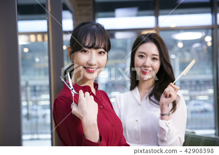 Hairdresser styling woman's hair in a salon. Korean beauty stock photo. 152 Hairdresser styling woman's hair in a salon. Korean beauty stock photo. 152 42908398