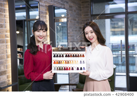 Hairdresser styling woman's hair in a salon. Korean beauty stock photo. 150 Hairdresser styling woman's hair in a salon. Korean beauty stock photo. 150 42908400