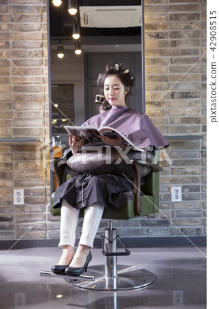 Hairdresser styling woman's hair in a salon. Korean beauty stock photo. 089 Hairdresser styling woman's hair in a salon. Korean beauty stock photo. 089 42908515