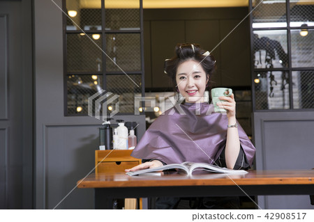 Hairdresser styling woman's hair in a salon. Korean beauty stock photo. 083 Hairdresser styling woman's hair in a salon. Korean beauty stock photo. 083 42908517