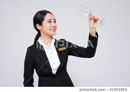 Catering services. Sommelier woman checking taste, smelling a wine isolated on white background 106 Catering services. Sommelier woman checking taste, smelling a wine isolated on white background 106 42908869