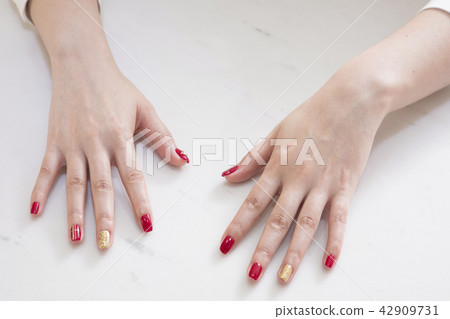 Nail salon woman hands treatment. Nail saloon woman painting color nail polish in hands stock photo. 080 42909731