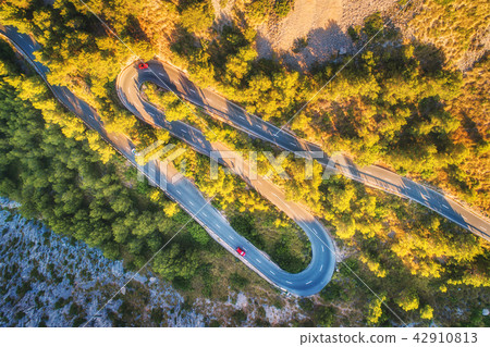 Aerial view of mountain curve road with cars 42910813