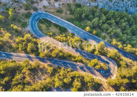 Aerial view of mountain curve road with cars 42910814