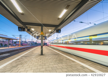 High speed train in motion on the railway station High speed train in motion on the railway station 42910827
