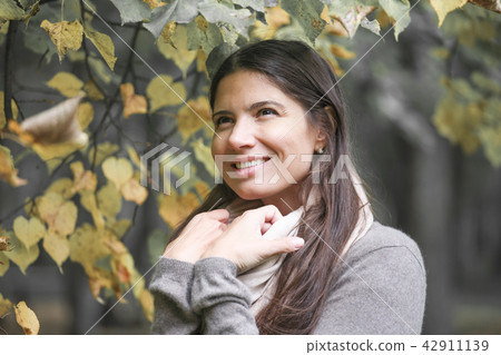 Beautiful brunette woman outdoors 42911139