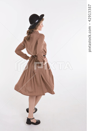girl dancing in loose dress on white background 42913387