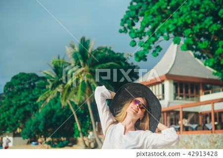 handsome girl in hat on the beach background handsome girl in hat on the beach background 42913428