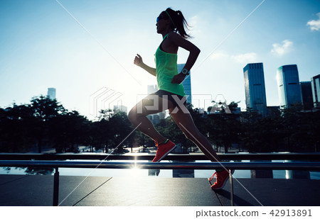 woman runner running on sunrise city woman runner running on sunrise city 42913891