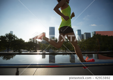 woman runner running on sunrise city 42913892
