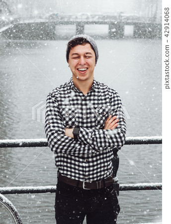 Guy is standing on a bridge 42914068