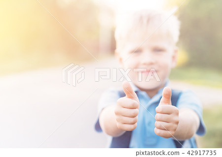 Chherful boy gives a thumbs-up. 42917735