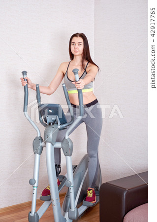 Sporty beautiful woman exercising at home to stay fit 42917765