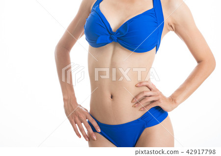 A young woman in a blue bikini swimwear 42917798