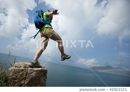 Woman walking off cliff edge with the eyes covered 42921521