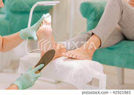 Professional female chiropodist working hard in her beauty salon Professional female chiropodist working hard in her beauty salon 42921965
