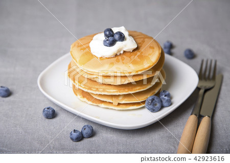 Pancakes with blueberries, sour cream and  honey 42923616