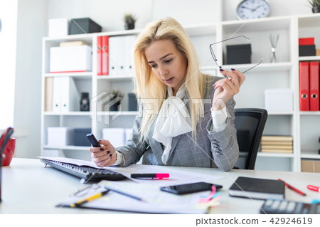 Young girl in the office working with a marker and documents. Young girl in the office working with a marker and documents. 42924619
