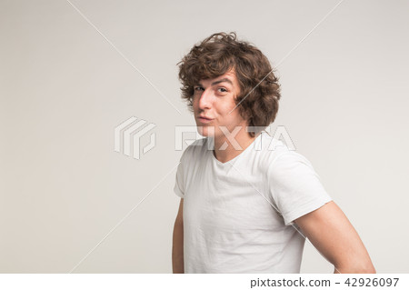 Handsome stylish young man having fun on white background with copy space Handsome stylish young man having fun on white background with copy space 42926097