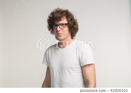 Portrait of serious stylish student man in glasses and casual outfit on white background Portrait of serious stylish student man in glasses and casual outfit on white background 42926101
