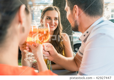 Beautiful woman and her best friends toasting with a refreshing drink 42927447