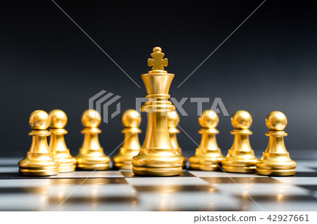 Gold king chess piece stand in front of pawn Gold king chess piece stand in front of pawn 42927661