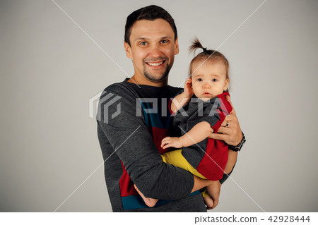 a little girl sitting on his father's hands a little girl sitting on his father's hands 42928444