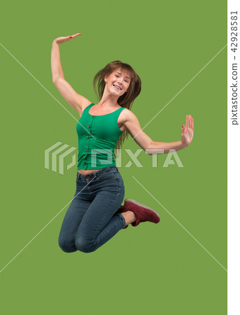 Freedom in moving. Pretty young woman jumping against orange background Freedom in moving. Pretty young woman jumping against orange background 42928581