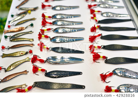 Different metal fishing lure on white 42928816