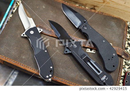 Folding knives on leather retro bag tablet Folding knives on leather retro bag tablet 42929415