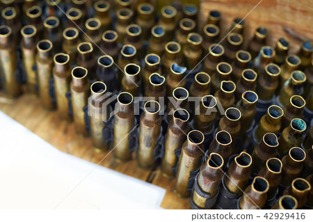 Brass cases of cartridges in machine-gun tape Brass cases of cartridges in machine-gun tape 42929416