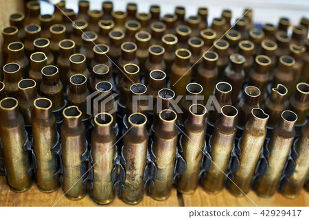 Brass cases of cartridges in machine-gun tape Brass cases of cartridges in machine-gun tape 42929417
