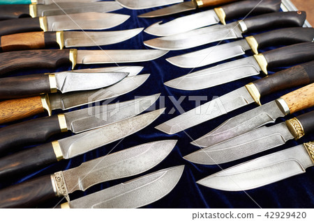 Forged hunting knives on dark 42929420
