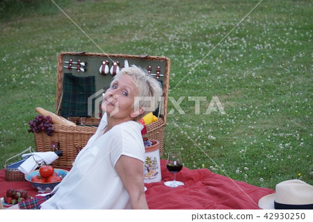 this young woman can relax at the picnic. 42930250
