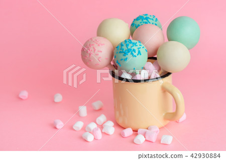 pink, blue, white icing pop cakes and marshmallows 42930884