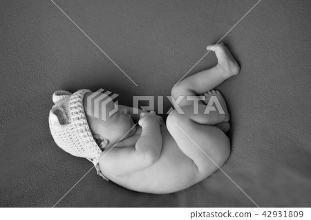 newborn baby lying on a white and black background newborn baby lying on a white and black background 42931809