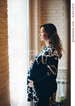 a pregnant woman on a lamps background a pregnant woman on a lamps background 42931828