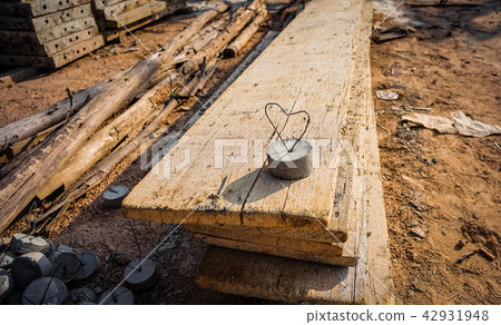 Wire in heart shape in the cement lump. Love sign 42931948