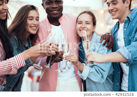 Beaming comrades celebrating with alcohol beverage Beaming comrades celebrating with alcohol beverage 42932528