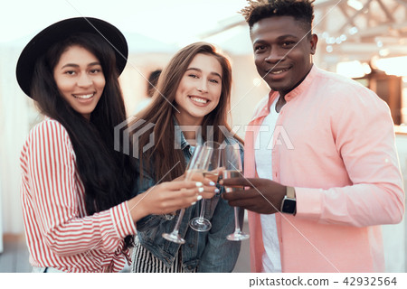 Glad comrades drinking champagne during party 42932564