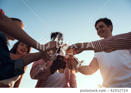 Happy men and girls drinking alcohol 42932724