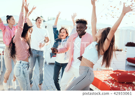 Satisfied women and males dancing during party Satisfied women and males dancing during party 42933061