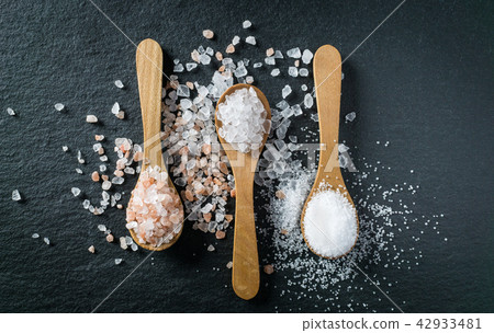 Different types of salt. Top view on wooden spoons 42933481
