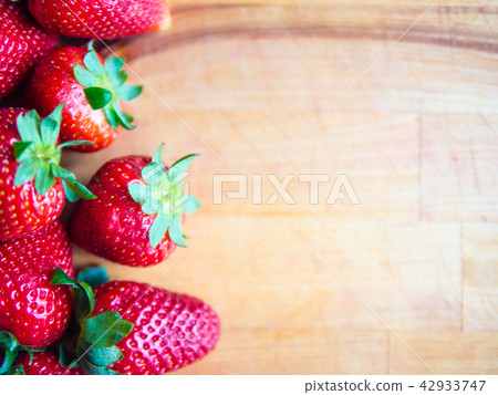 Strawberries on a wooden board with empty space Strawberries on a wooden board with empty space 42933747