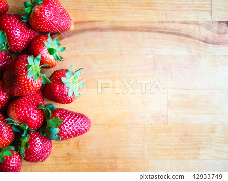 Strawberries on a wooden board with empty space Strawberries on a wooden board with empty space 42933749