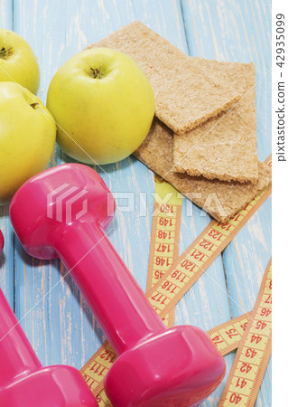 The concept of a healthy diet. Small dumbbells. healthy lifestyle. sport. Fitness food. The concept of a healthy diet. Small dumbbells. healthy lifestyle. sport. Fitness food. 42935099